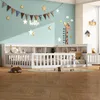 A child's bedroom with a white bed frame, decorated with stars and a giraffe growth chart on the wall. Anteprima dell’immagine prodotto