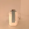 A white electric kettle with a gray handle and silver lid is shown from the side. Voir les images du produit