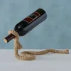 A wine bottle is held up by a rope stand. Produktbild-Vorschau