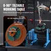 A welding positioner with a tiltable working table and a welding chuck, set in a workshop environment with tools on the wall. Podgląd zdjęcia produktu
