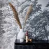 A black console table with a ribbed wood-look finish, adorned with a white vase containing dried pampas grass and decorative candles. Produktbild-Vorschau