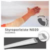 A hand installing a white styrofoam ceiling molding. Produktbild-Vorschau