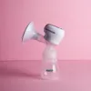 A white electric breast pump with a clear bottle is placed on a pink background. Podgląd zdjęcia produktu