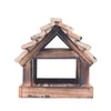 A wooden bird feeder with a pitched roof made of small wooden pieces. Podgląd zdjęcia produktu