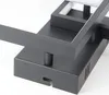 Close-up view of a black modern lamp base with a square frame detail. Produktbild-Vorschau