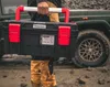 A person is carrying a toolbox next to a vehicle. Anteprima dell’immagine prodotto