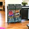 A metal shelving unit holding crates of bottles, apples, and wine bottles in a room with wooden floors. Produktbild-Vorschau