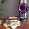A portable fan is placed on a table next to bowls of food and bread. Produktbild-Vorschau