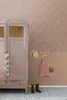 A child's room with a pink wardrobe, a pink dress hanging on a rack, and cowboy boots on the floor. Podgląd zdjęcia produktu
