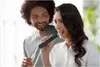 A man and a woman are brushing their teeth together. Produktbild-Vorschau