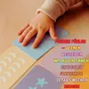 A child's hand is touching sensory learning cards on a wooden surface. Produktbild-Vorschau