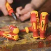 Several screwdrivers are laid out on a colorful, worn wooden surface, with hands in the background holding another tool. Produktbild-Vorschau