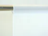 A white fabric curtain hanging from a metal rod. Produktbild-Vorschau
