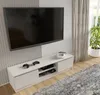 A modern living room with a TV mounted on the wall above a white TV stand. There are two game controllers on the TV stand, and a plant in a pot near the window. Voir les images du produit