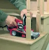 A person is using a belt sander on a wooden staircase. Anteprima dell’immagine prodotto
