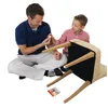 A father and son are assembling a chair, with the son holding a small white object. Anteprima dell’immagine prodotto