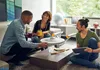 Three people are sitting around a coffee table in a living room, with a model of the Starship Enterprise on the table. Podgląd zdjęcia produktu