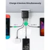 A UGREEN 65W GaN Tech Fast Wall Charger is shown charging multiple devices simultaneously, including a Nintendo Switch, wireless earbuds, and two smartphones. Produktbild-Vorschau
