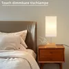 A bedside table with a touch-dimmable lamp next to a bed. Náhľad obrázku produktu
