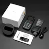 A collection of items for a senior's mobile phone, including the phone itself, its box, charger, battery, and manual, laid out on a dark surface. Produktbild-Vorschau