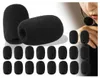A collection of black foam microphone covers, with a person wearing a headset in the background. Produktbild-Vorschau