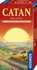 The image shows the front and side of a Catan board game expansion box, featuring a landscape illustration with a large sun. Anteprima dell’immagine prodotto