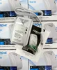 A white gas and carbon monoxide detector is shown in the center of the image, surrounded by boxes of the same product. Podgląd zdjęcia produktu
