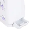 Close-up of a white mini sewing machine with purple accents, showing a small pull-out drawer. Produktbild-Vorschau