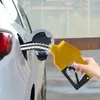 A hand is holding a yellow diesel pump nozzle, filling a white car with fuel. Produktbild-Vorschau