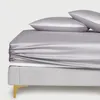 A close-up view of a bed with a fitted sheet and two pillows. Anteprima dell’immagine prodotto