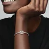 Close-up of a person's arm wearing a Pandora charm bracelet with an elephant charm. Podgląd zdjęcia produktu