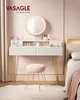 A vanity table with a stool and a round mirror with lights, set in a bedroom. Produktbild-Vorschau