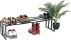 A black metal shoe rack with various shoes and boots placed on it, next to a potted green plant. Podgląd zdjęcia produktu