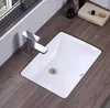 A white rectangular sink with a chrome faucet is placed on a wooden countertop. Náhľad obrázku produktu