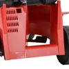 A close-up view of the rear section of a red electric lawnmower, showing the grass collection chute and part of a wheel. Produktbild-Vorschau