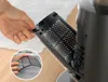 A hand is shown removing a filter from a household fan. Podgląd zdjęcia produktu