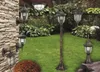 A collection of outdoor lighting fixtures arranged in a garden setting. Náhled obrázku produktu