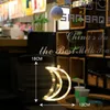 A decorative moon-shaped light hanging in a window or on a wall, with text overlays indicating dimensions and branding. Produktbild-Vorschau