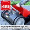A person is holding the handle of a red and black lawn sweeper, showing its collection bin. Produktbild-Vorschau