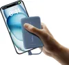 A hand is holding a blue power bank and charging a smartphone. Produktbild-Vorschau