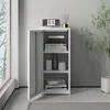 A white metal cabinet with its door open, showing shelves with books and decorative items, placed next to a window and a plant. Voir les images du produit
