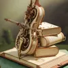 A close-up of a mechanical wooden cello model with gears, resting on a stack of wooden books. Voir les images du produit