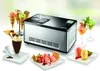 An ice cream maker with various ice cream desserts and cones displayed around it. Produktbild-Vorschau