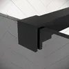 A close-up view of a black metal frame and glass panel of a shower enclosure, with a herringbone tile pattern in the background. Anteprima dell’immagine prodotto
