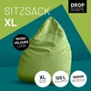 A light green beanbag chair is shown against a green and teal background with text and icons. Voir les images du produit