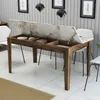 A dining table with its lid open, revealing storage compartments, in a modern dining room setting. Produktbild-Vorschau