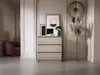 A modern living room with a dresser, chair, and decorative items. Voir les images du produit