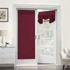 A burgundy door curtain is shown on a glass door, with a white dresser and lamp to the left. Produktbild-Vorschau
