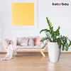 A modern living room with a wooden sofa, cushions, a plant in a white pot, and a large yellow painting on the wall. Náhľad obrázku produktu