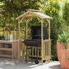 A wooden grill shelter with a barbecue grill set up in a backyard patio setting. Podgląd zdjęcia produktu